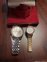 Image of the two watches and red box with watch cushion insert