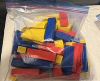 Plastic Fisher Price style stacking blocks in a resealable bag showing various brightly colored blocks for building