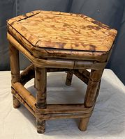 Photo showcasing the bamboo plant stand with hexagonal top and sturdy bamboo frame and legs.