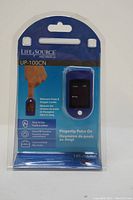 Clear blister pack showing the front of the packaged LifeSource UP-100CN Fingertip Pulse Oximeter device.