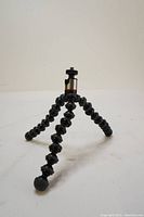 JOBY GorillaPod 325 flexible tripod shown standing with three segmented black legs with rubberized grips and metal mounting thread visible on top.