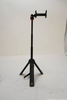 Full view of the JOBY TelePod Mobile Tripod extended with smartphone holder mounted, showing the three legs and black finish.