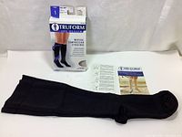 Full view of the Truform compression stocking including packaging and instruction leaflet against a light background.