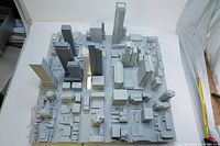 Front angle of the wooden 3D model showing dense downtown Toronto buildings with one illuminated transparent building.