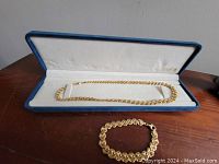 Open blue display box with necklace laid inside