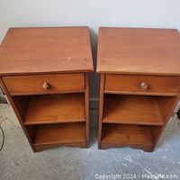 Frontal view of both nightstands side by side on concrete floor