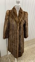 Front view of full length brown fur coat with lapel collar on mannequin