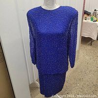 Full front view of vintage blue sequin embellished dress on mannequin