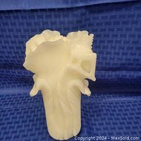 Front view showing carved detailed leaves and stalk of white jadeite cabbage sculpture.