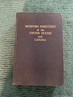 Front cover of the Museums Directory book with gold embossed title on brown hardcover.