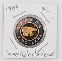 Reverse of 1997 Canadian $2 Toonie coin featuring a gold-plated polar bear with inscriptions on silver-toned frosted proof finish.