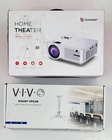 Box showing Bomaker C9 projector branding and Vivo VP02W ceiling mount box, highlighting the items included in the lot.