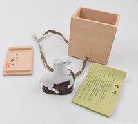 Ceramic horse figurine with wooden box open lid and certificate/bio paper laid out