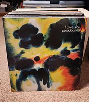 Photo shows a front-view of a vinyl record with the abstract colorful cover titled "I Love You" by Pseudodoxia