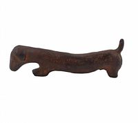 Side view of small solid bronze Wiener dog statue showing elongated body, head, legs and raised tail.