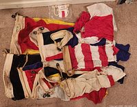 Pile of folded flags and pennants in various colors and patterns