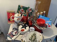 Full lot with tea pot, glasses, plates, ornament decorations, mug, trays, tin box, wrapping paper, story book, and figurines