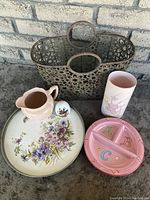Photo of metal basket with floral cut-out design, pink jug, floral tray, divided baby plate and Avon Autumn egg-shaped vase