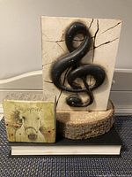 Two plaques displayed on books, including Sid Dickens and Cedar Mountain plaques