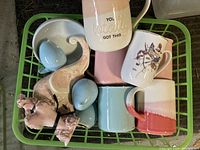Photo showing all items in the lot, including pastel-colored mugs, the retro poodle shallow bowl, bird and elephant figurines.
