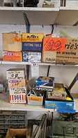Two shelves showing multiple labeled cardboard boxes of parts