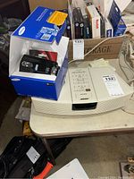Bose Wave Radio on table next to Samsung camcorder box showing both items together