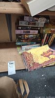 Stack of paperback books on shelf including Mercedes Lackey titles and others