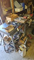 Steel workbench with granite top, tools on surface and bins below