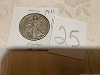 Front side of 1941 Walking Liberty half dollar coin showing Lady Liberty walking with sun in background and date 1941.