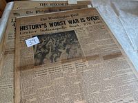 Photograph showing front page of The Washington Post with headline "HISTORY'S WORST WAR IS OVER! Cruiser Indianapolis Sunk, 870 Lost" including crowd photo and related WWII news articles.