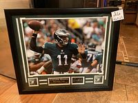 Full frontal view of the framed Carson Wentz photo showing the dimensions 26x23 with the bottom plaque and autograph window visible.