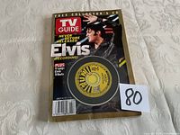 Photo of TV Guide magazine with Elvis Presley on cover and attached collectible CD in plastic.
