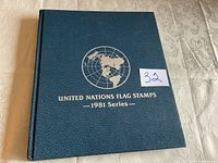 Blue presentation album with gold lettering reading 'United Nations Flag Stamps - 1981 Series' on the cover.