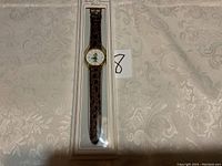 Full view of the vintage Keebler watch in original packaging showing the brown strap and gold-tone bezel.