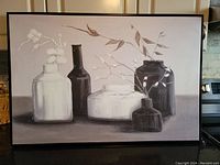 Frontal view of a black and white still life painting on thin canvas showing five vessels with floral elements, framed size 37 x 25 inches.