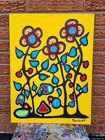 Full front view of the painting against a brick wall backdrop.