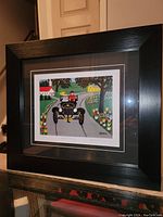 Framed fine art print by Maud Lewis showing full view of the frame and print titled 'Model T Ford'