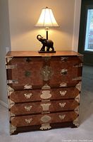 Full front view of cabinet with elephant lamp on top