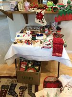 Overview of Christmas decorations, table linens, hand towels, and some boxed items.