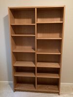 Front view of the wooden shelving unit showing two vertical sections with adjustable shelves.
