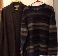 Photo of men's dark brown Naturallife wool jacket and multi-colored striped wool sweater hanging, showing styles and fabric.