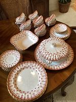 Full set laid out showing plates, bowls, cups and serving pieces.