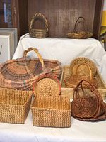 Front angled view showing all seven baskets arranged on steps, diverse shapes and weave styles