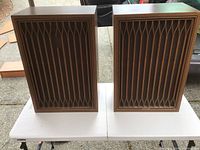 Pair of large Kenwood KL-777D speakers on a table, showing front decorative panels with vertical lattice design and overall condition.