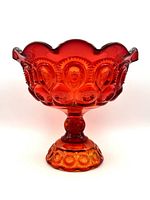 Front angle view of the vintage amberina glass candy dish showing red and yellow gradient colors, ruffled edge, and moon and stars pattern