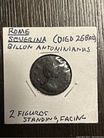 Front side of the coin displaying Severina's bust and handwritten label with details about the coin's origin, date, and figures depicted.