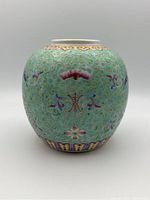 Front view of the ginger jar showing turquoise glaze with cloud and floral patterns, no lid visible.