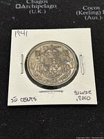 Obverse side of the 1941 Canadian 50 cents coin showing the Canadian coat of arms with 'CANADA 1941' inscriptions.