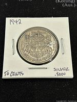Reverse side of the 1942 Canadian 50 cents silver coin showing the Canadian coat of arms and denomination.