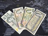 Full view of four Canadian $20 banknotes laid out to show different designs and colors representing the years 1954, 1969, 1979, and 1991.